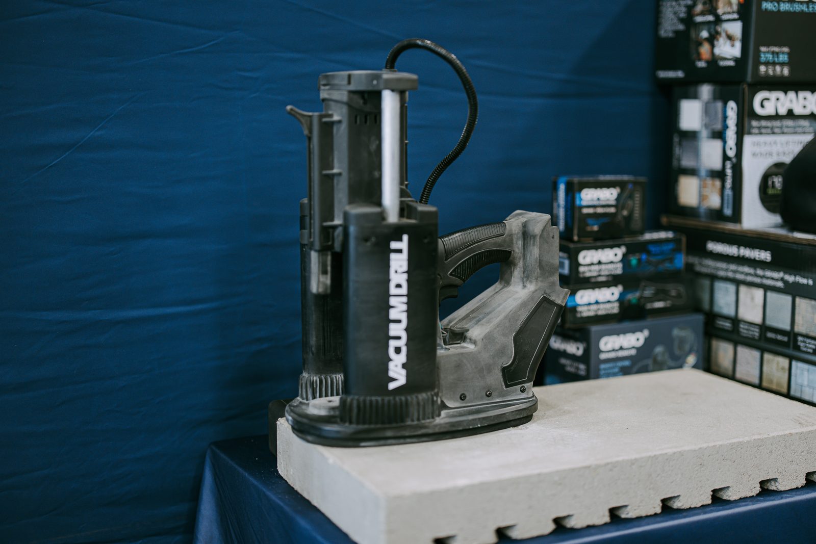 VACDRILL standing on a concrete sample in a GRABO workshop display